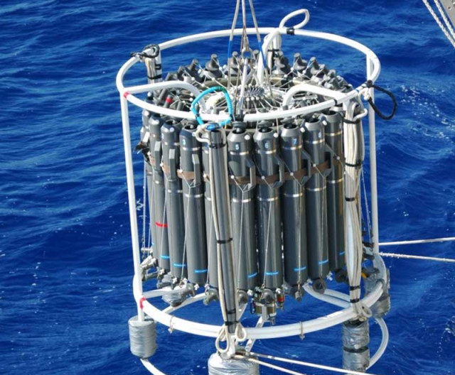 Researchers deploy a device called a CTD-rosette to collect deep water samples in the Bermuda Atlantic Time-series Study.